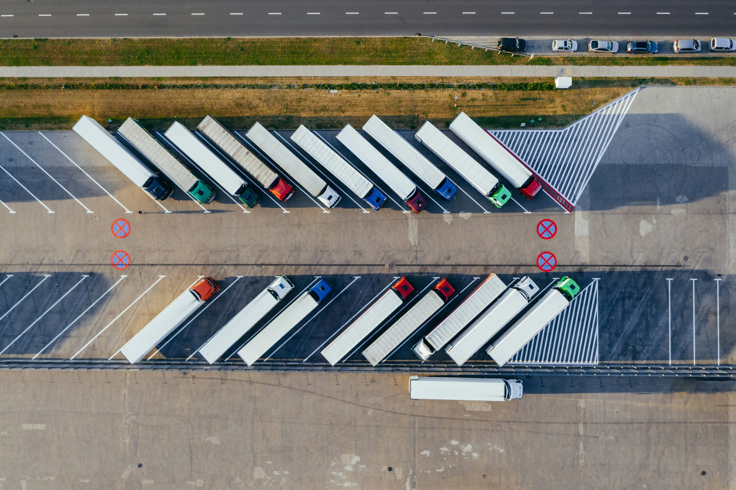 Aerial view of trucks parked in formation at a depot